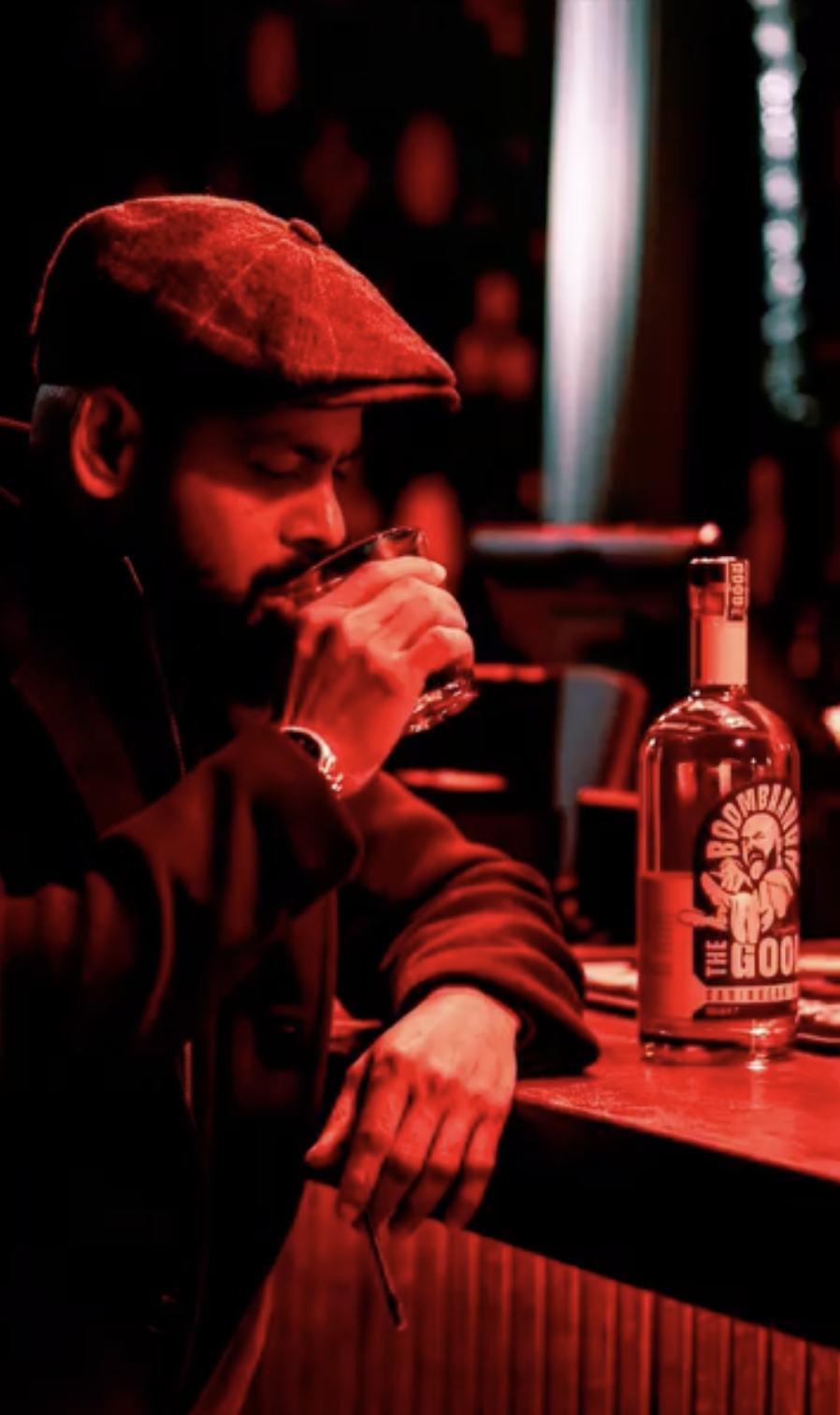 A glass of Boombangh poured neat in a red-lit bar